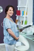 Pregnant woman reading notebook