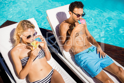 Couple relaxing on deckchairs