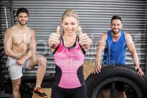 Fit people posing with thumbs up