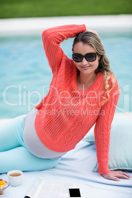 Pregnant woman relaxing outside