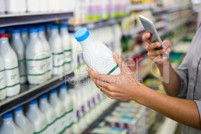 Woman taking picture of some milk