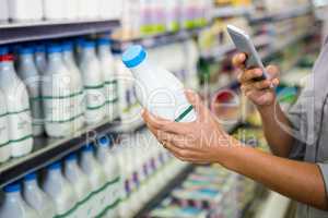 Woman taking picture of some milk