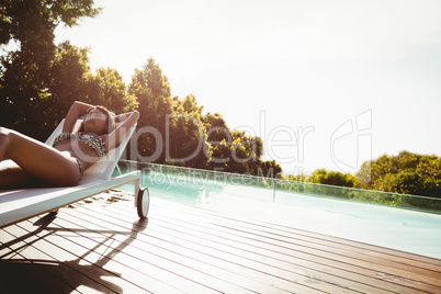 Fit woman lying on deck chair