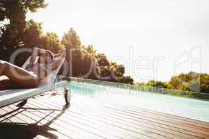 Fit woman lying on deck chair