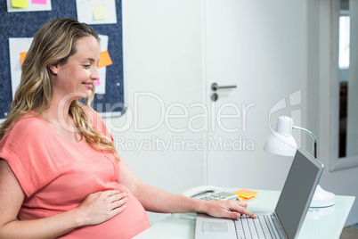 Pregnant woman using laptop