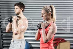 Couple lifting dumbbells together