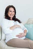 Pregnant woman resting on couch