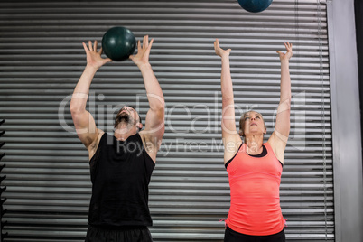 Couple throwing ball in the air