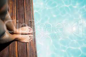 Woman feet on pools edge