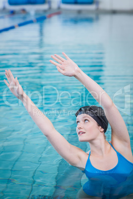 Fit woman stretching in the water