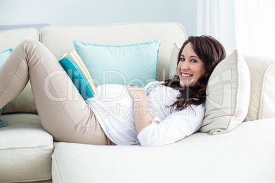 Pregnant woman reading a book