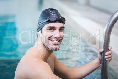 Handsome man getting out of water