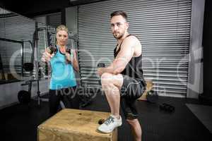 Couple posing with dumbbells