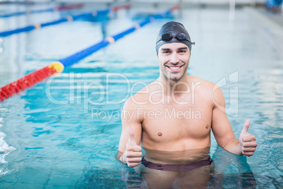 Handsome man with thumbs up in the water