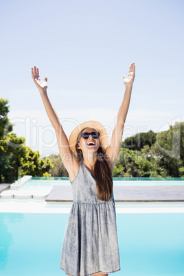 Smiling brunette raising hands