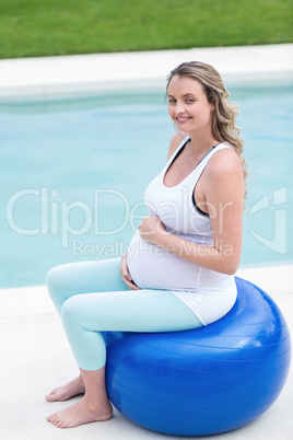 Pregnant woman sitting on exercise ball