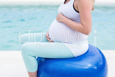 Pregnant woman sitting on exercise ball