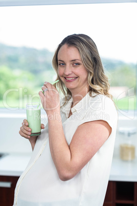 Pregnant woman drinking a smoothie