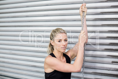 Fit woman holding chain