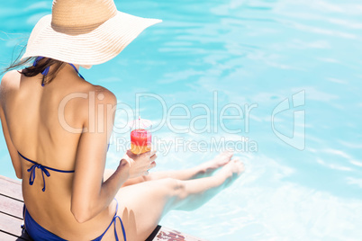 Woman with hat with cocktail