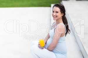Pregnant woman sitting on stairs