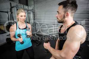 Couple posing with dumbbells