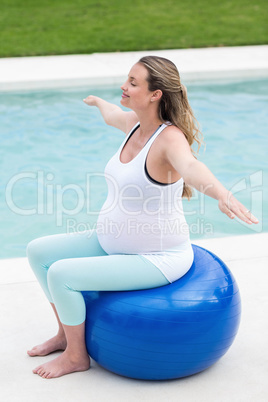 Pregnant woman sitting on exercise ball