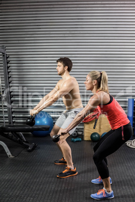 Couple lifting dumbbells together