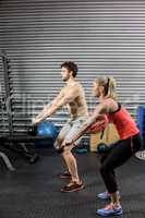 Couple lifting dumbbells together