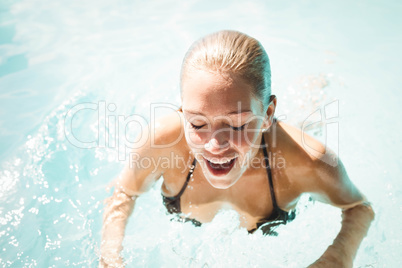 Smiling blonde heading out of water