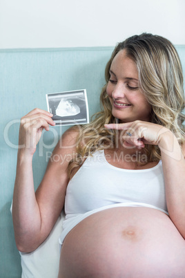 Pregnant woman showing an ultrasound picture