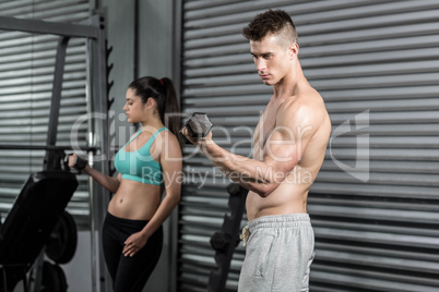 Fit people lifting dumbbells