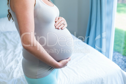 Pregnant woman touching her belly