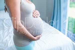 Pregnant woman touching her belly