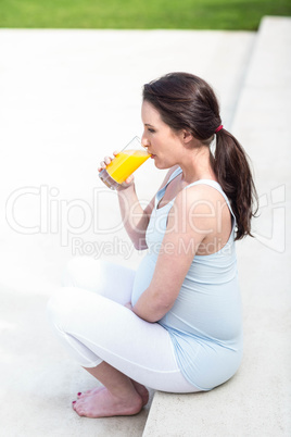 Pregnant woman sitting on stairs