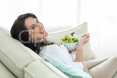 Pregnant woman eating salad