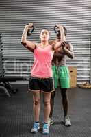 Fit couple lifting dumbbells