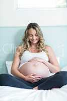 Pregnant woman touching her belly