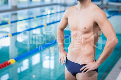 Fit man standing with hands on hips