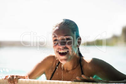 Beautiful blonde in the pool smiling