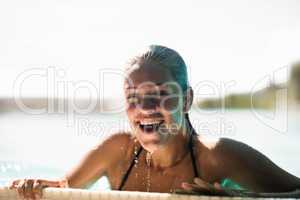 Beautiful blonde in the pool smiling