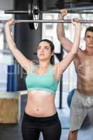 Fit couple lifting barbell