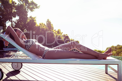 Fit woman lying on deck chair