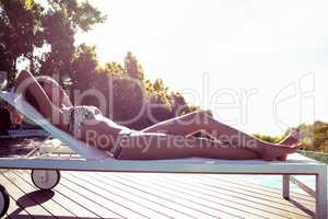 Fit woman lying on deck chair