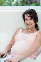 Pregnant woman relaxing with her laptop