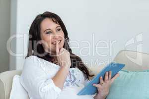 Pregnant woman resting on couch