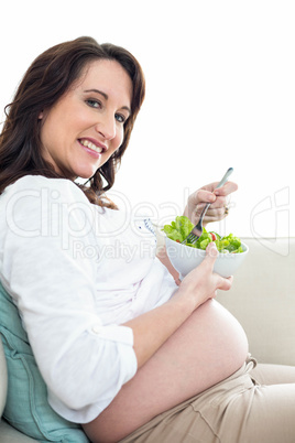 Pregnant woman eating salad