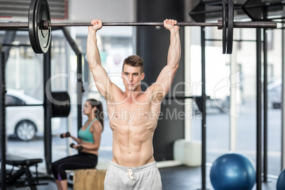 Fit couple lifting dumbbells