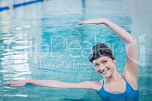 Fit woman stretching in the water