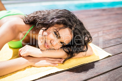 Fit brunette lying on towel